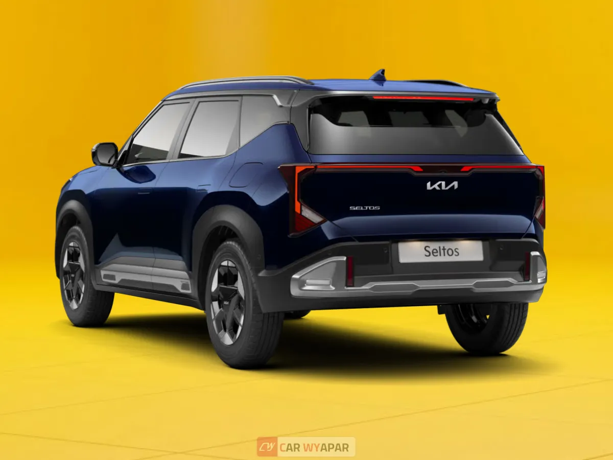 Rear three-quarter view of a dark blue Kia Seltos parked on a yellow surface, highlighting its modern LED taillights and rugged bumper.